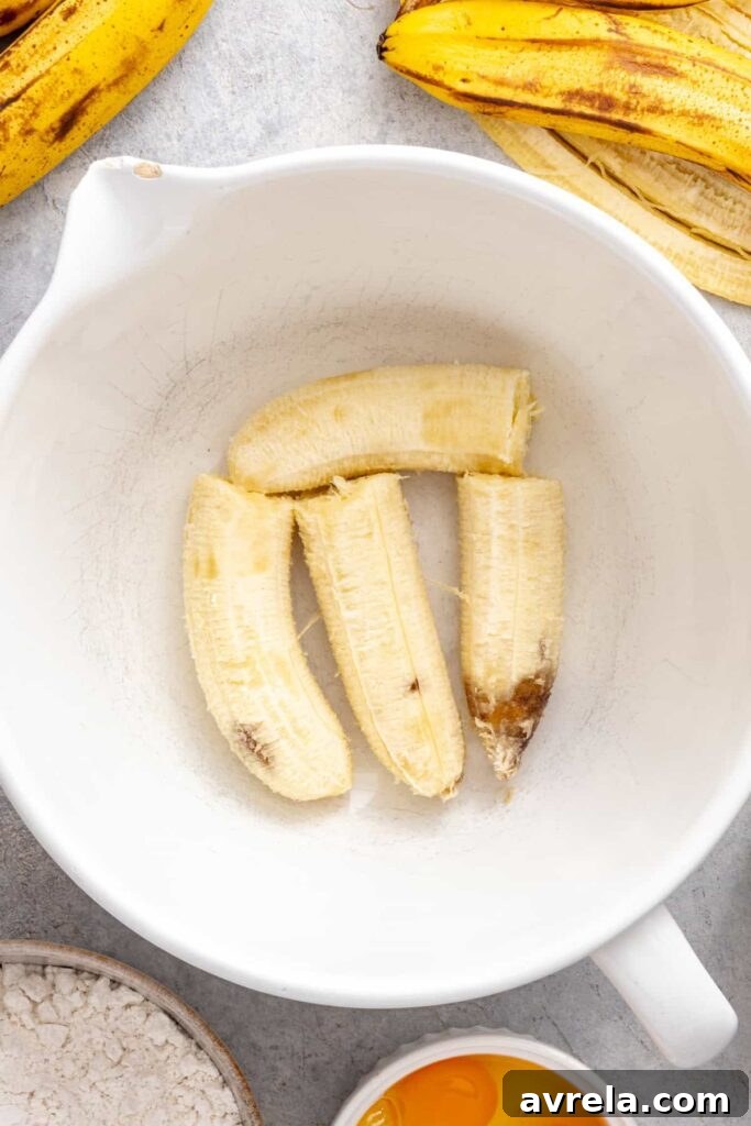 ripe bananas in a bowl, ready to be mashed for a healthy banana cake