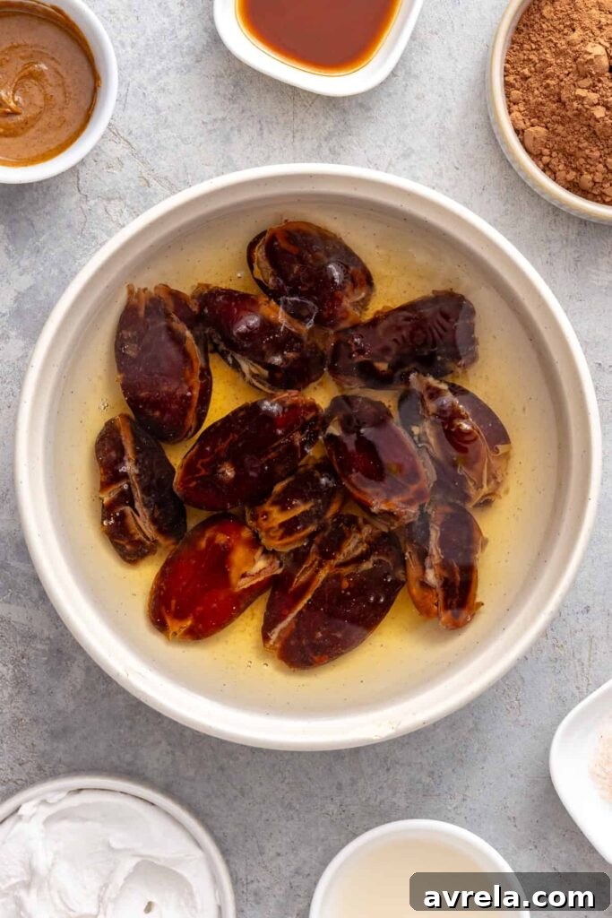 Pitted Medjool dates soaking before blending into chocolate frosting