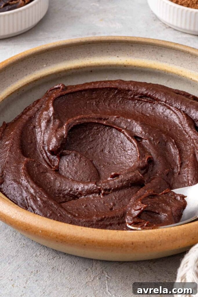 Rich chocolate date frosting showing its smooth texture