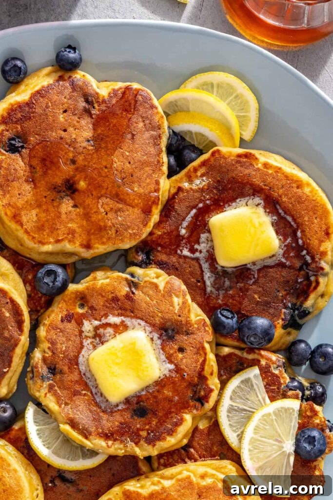 Close-up high-protein cottage cheese pancakes topped with butter and blueberries