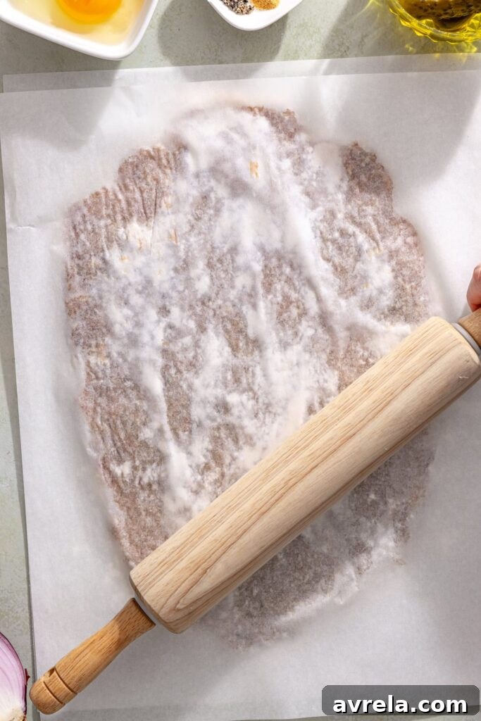 Pressing ground chicken into a thin giant chicken cutlet between parchment