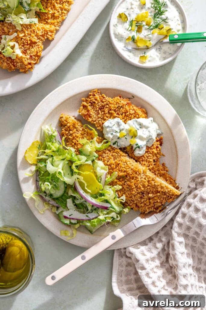 Single serving of crispy pickle chicken cutlet with creamy dill salad and pickle ranch