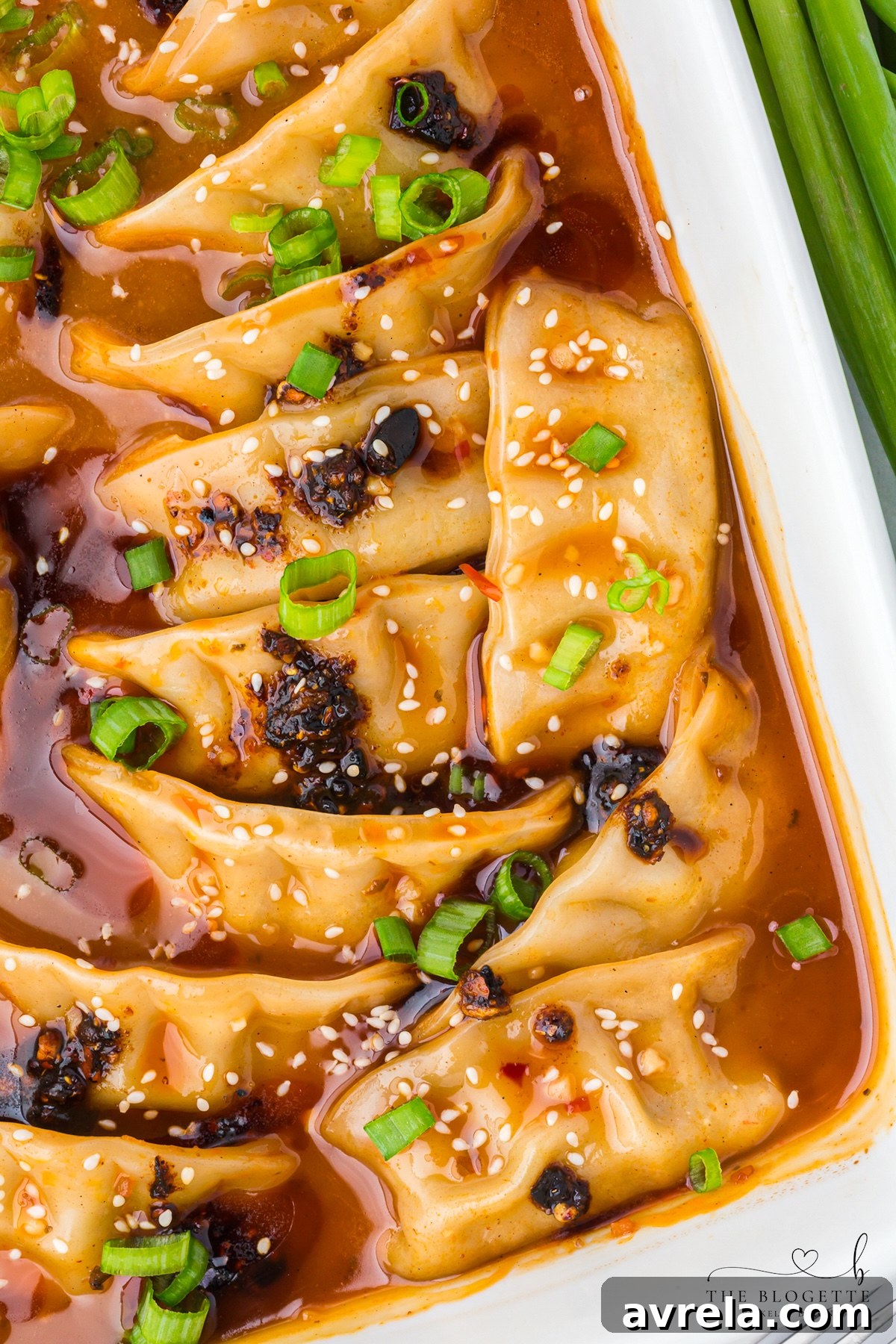 Coconut curry dumpling bake with green onions and sesame seeds