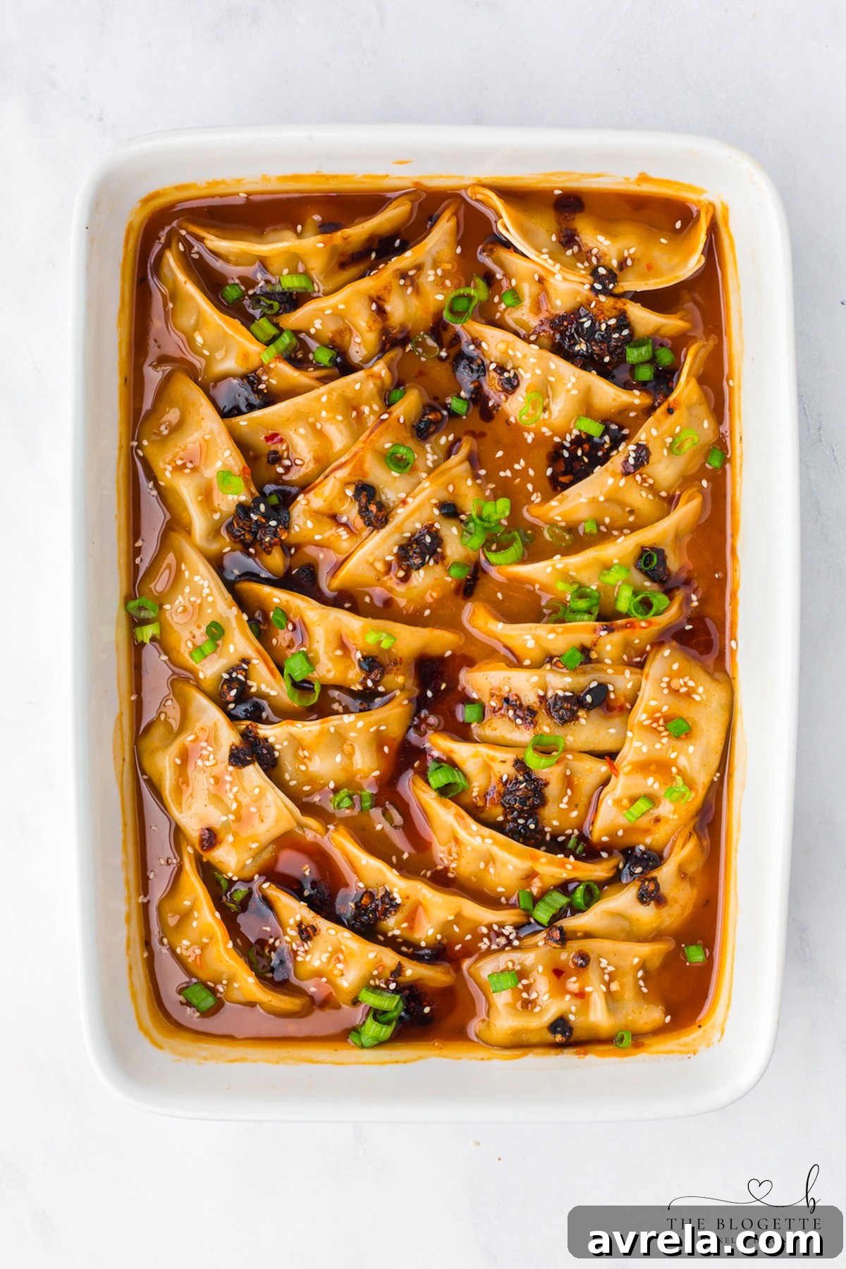 Chicken potstickers baked in creamy coconut red curry sauce