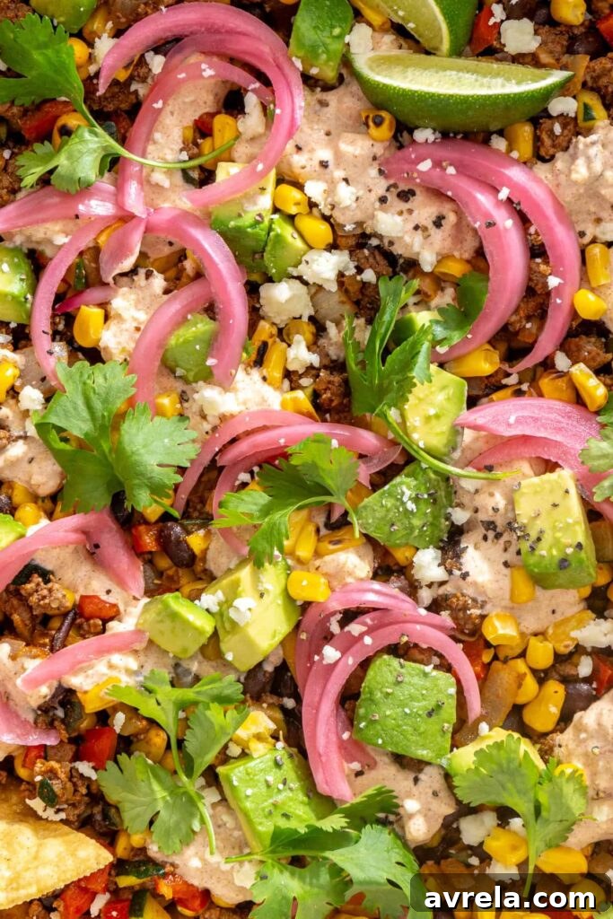 High-Protein Street Corn Taco Skillet One-Pan Dinner 3 Close-up of street corn taco skillet with seasoned ground beef, black beans, fire-roasted corn, and creamy cotija sauce