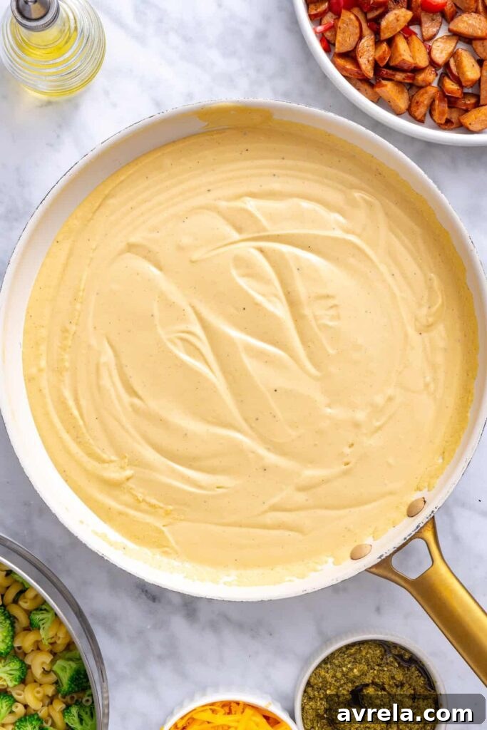 Blended cottage cheese cheddar sauce poured into a skillet to thicken
