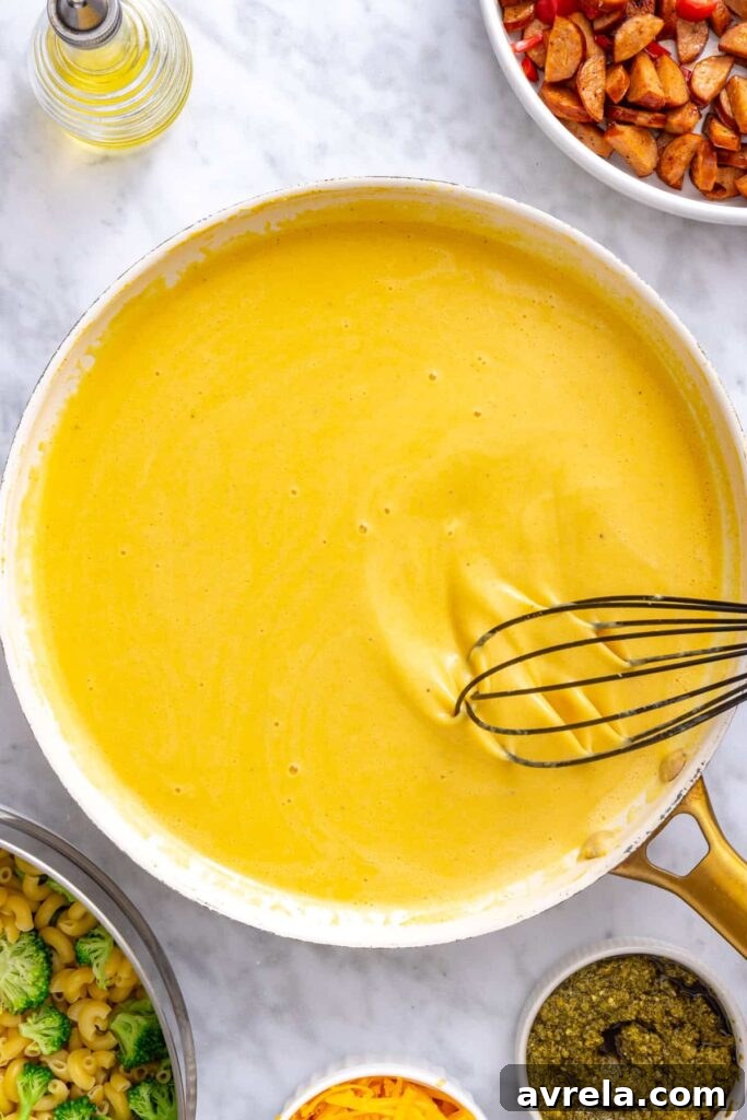 Cottage cheese cheddar sauce gently heating and thickening in a skillet