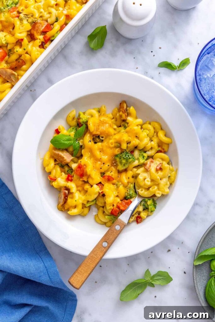 Single serving of broccoli cheddar pasta in a pasta bowl garnished with fresh basil