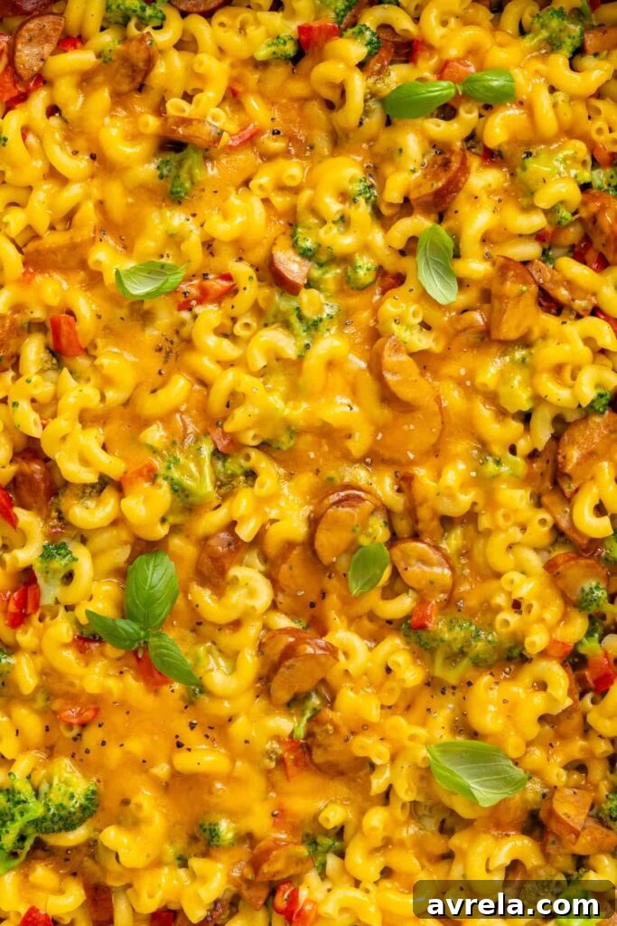 Close-up of creamy broccoli cheddar pasta showing tender pasta, broccoli and melted cheddar