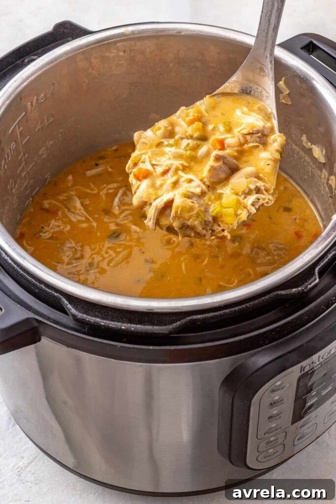 Close-up Instant Pot buffalo chicken chili with a ladleful of creamy chili