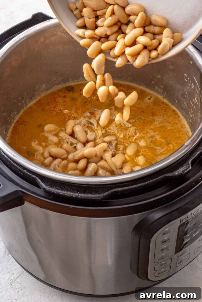 Whole cannellini beans added to buffalo chicken chili in the Instant Pot