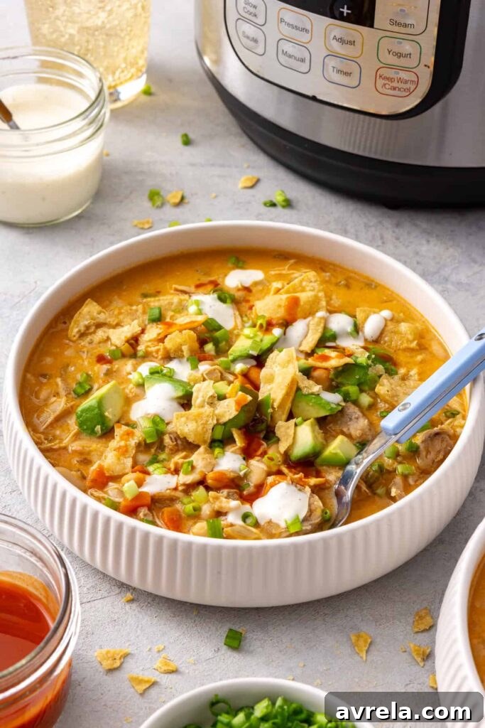 Side angle bowl of buffalo chicken chili with the Instant Pot in the background
