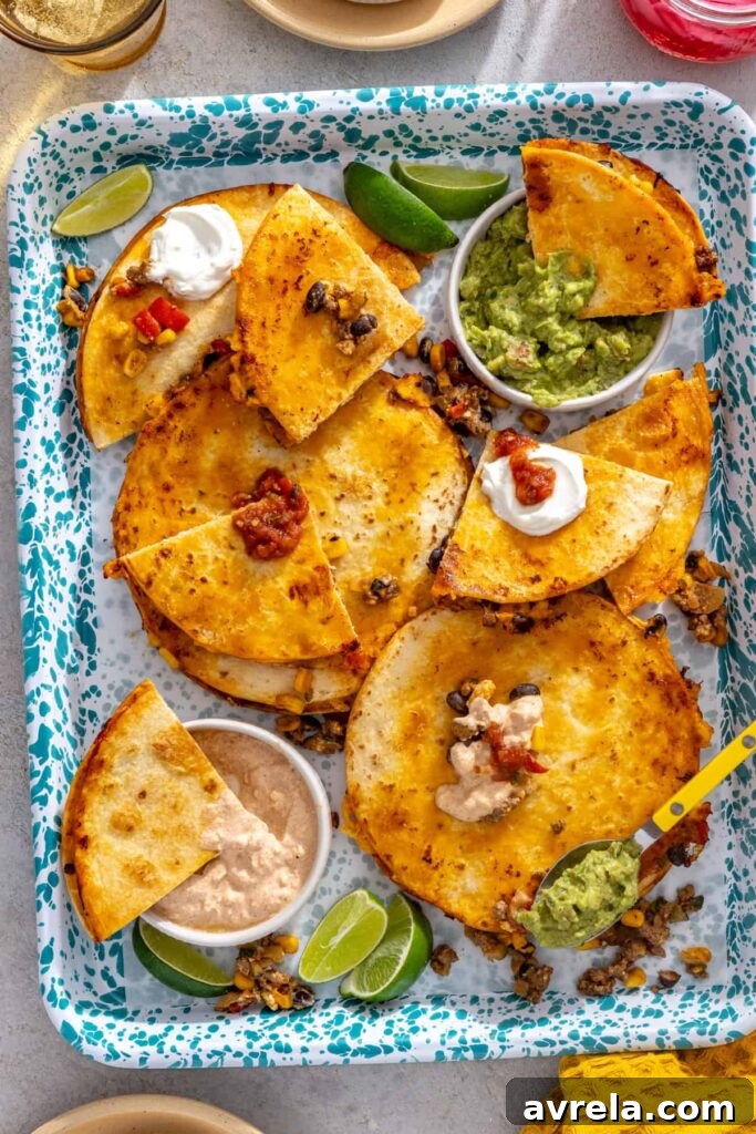 Crispy quesadilla wedges served with extra street corn filling, guacamole and lime