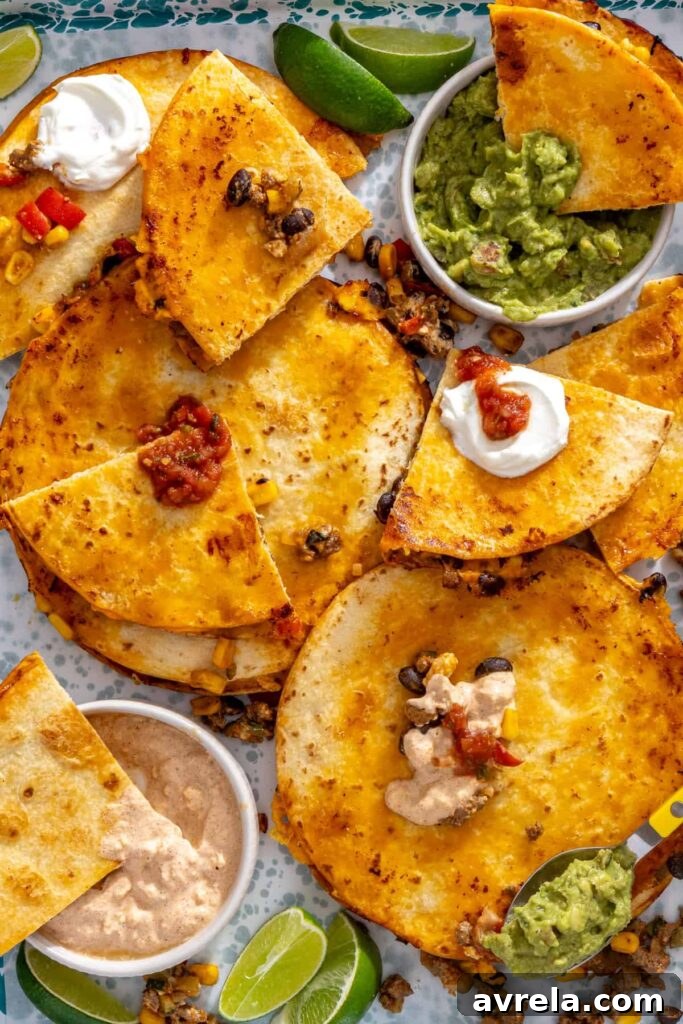 Golden quesadilla wedges served with guacamole, lime and extra taco filling