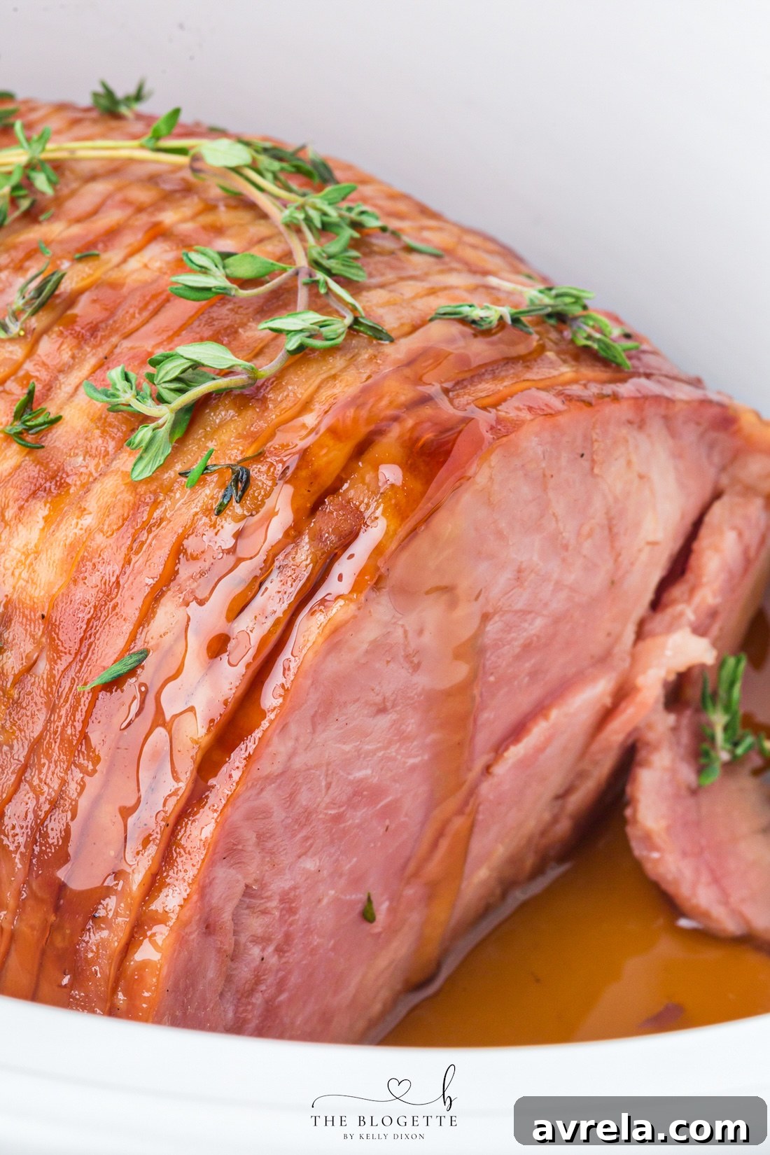 Make tender Crock Pot Ham with a maple brown sugar glaze, pineapple juice, butter, and thyme. An easy holiday ham recipe made in the slow cooker!