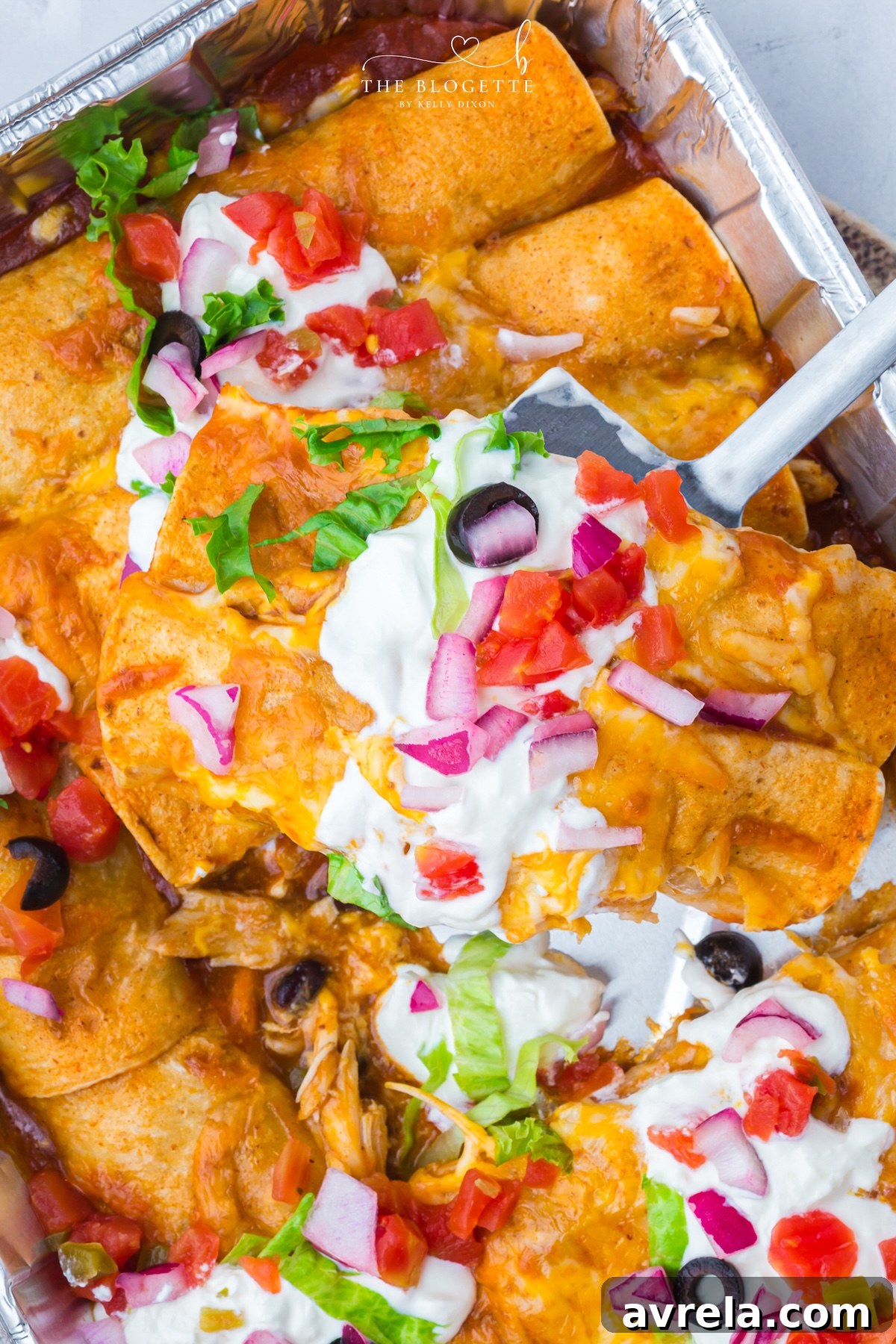 These Freezer Chicken Enchiladas make busy-night dinners so much easier! Crockpot chicken, black beans, green chiles, red enchilada sauce, and plenty of melted cheese come together in a recipe that makes TWO pans. Bake one tonight and freeze one for later!