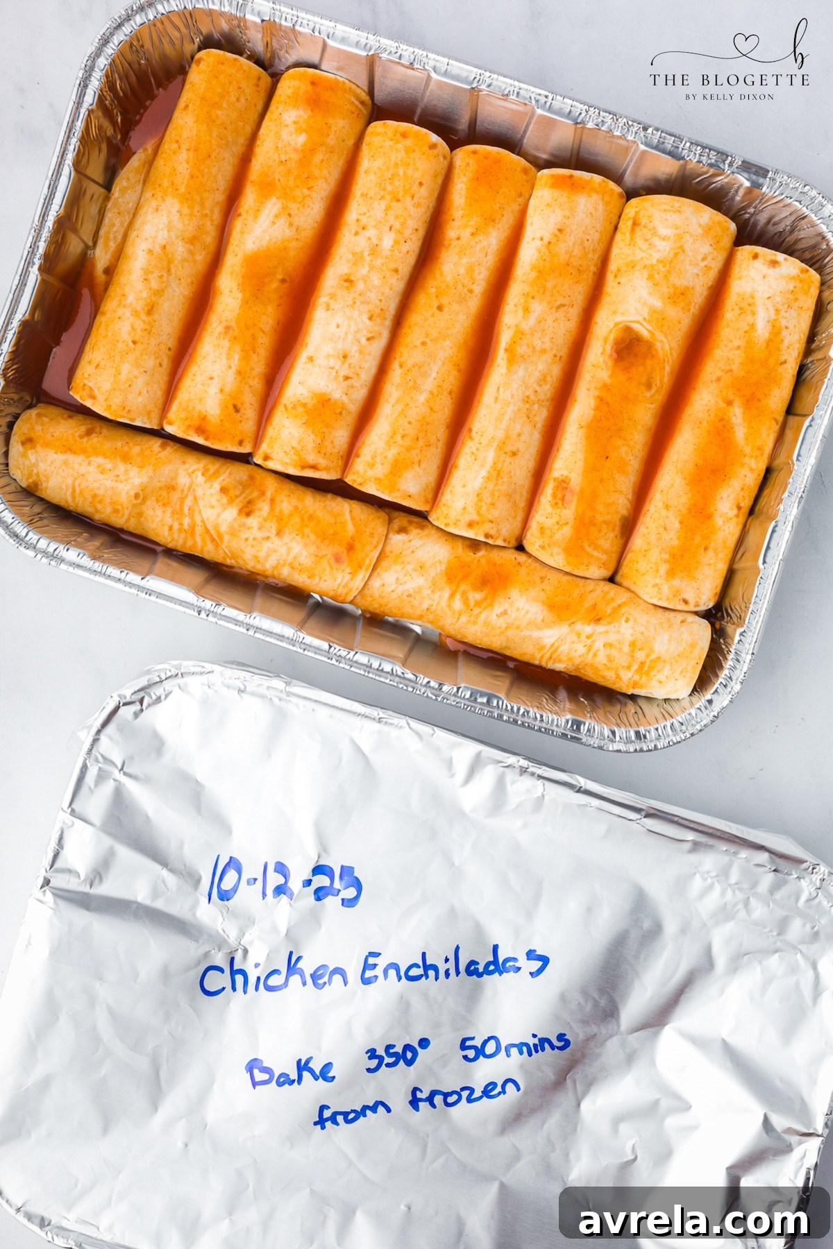 These Freezer Chicken Enchiladas make busy-night dinners so much easier! Crockpot chicken, black beans, green chiles, red enchilada sauce, and plenty of melted cheese come together in a recipe that makes TWO pans. Bake one tonight and freeze one for later!